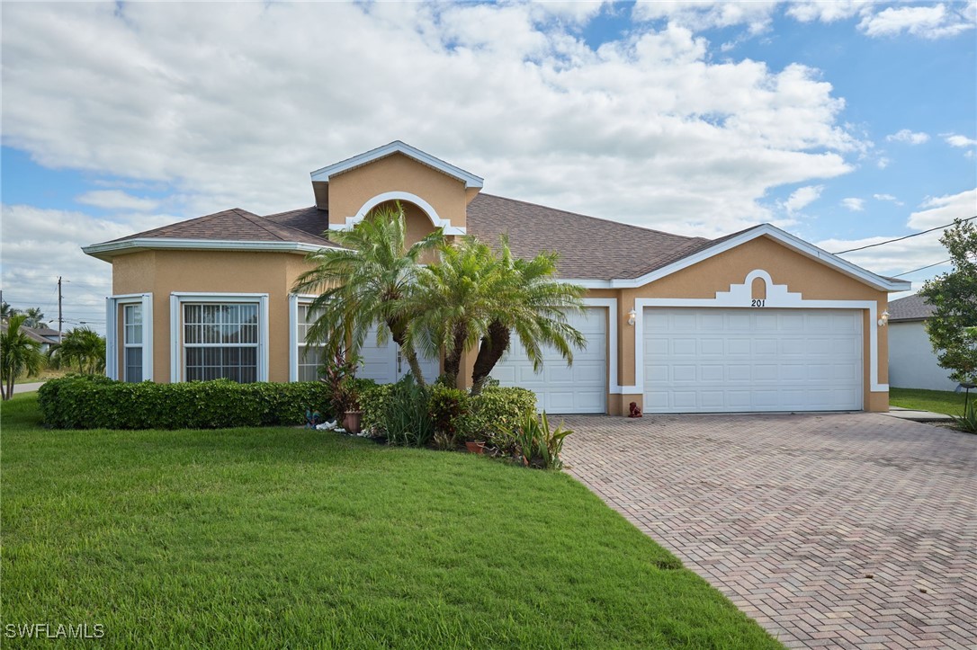 a front view of a house with a yard and garage