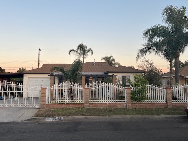 Large front yard with gate and car port.