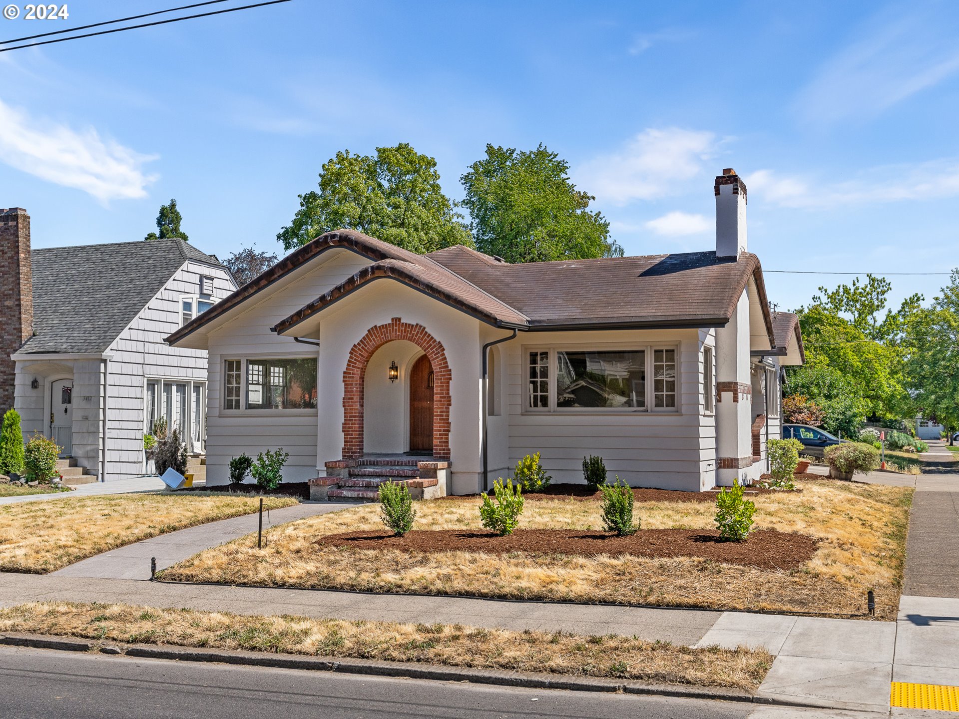 a front view of a house with garden