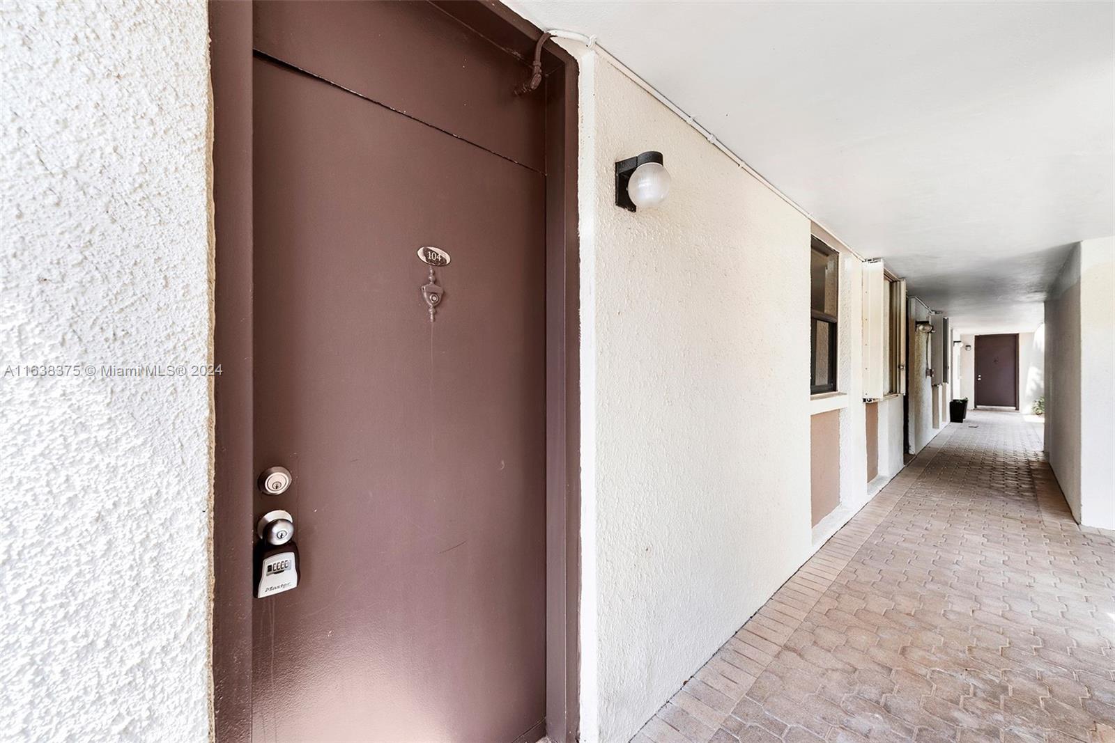 a view of a hallway with wooden floor and stairs