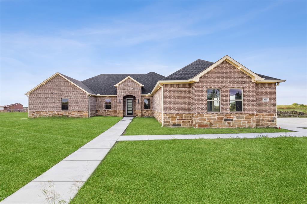 a front view of house with yard and green space