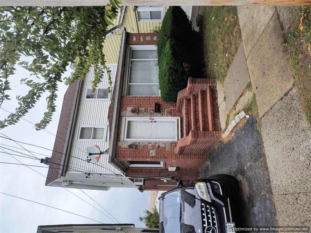 a view of a car parked front of a house