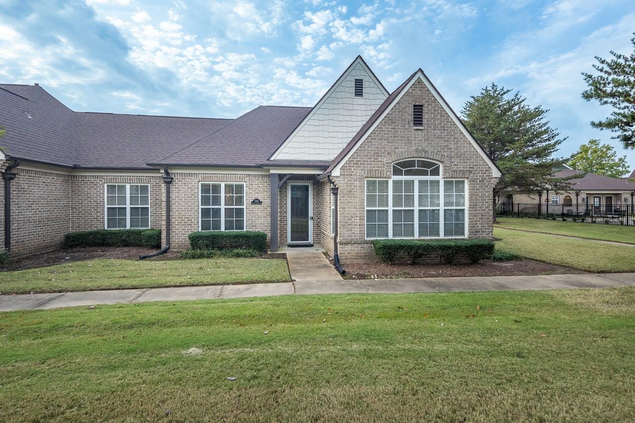 a front view of a house with a yard