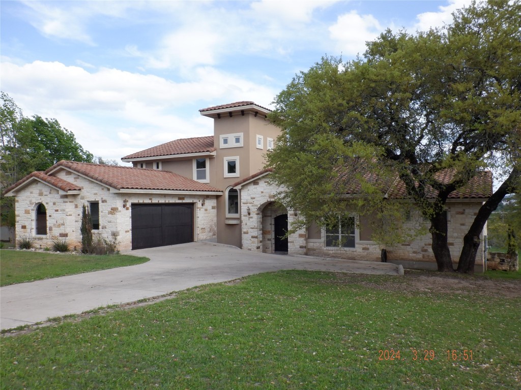 a front view of house with yard and green space