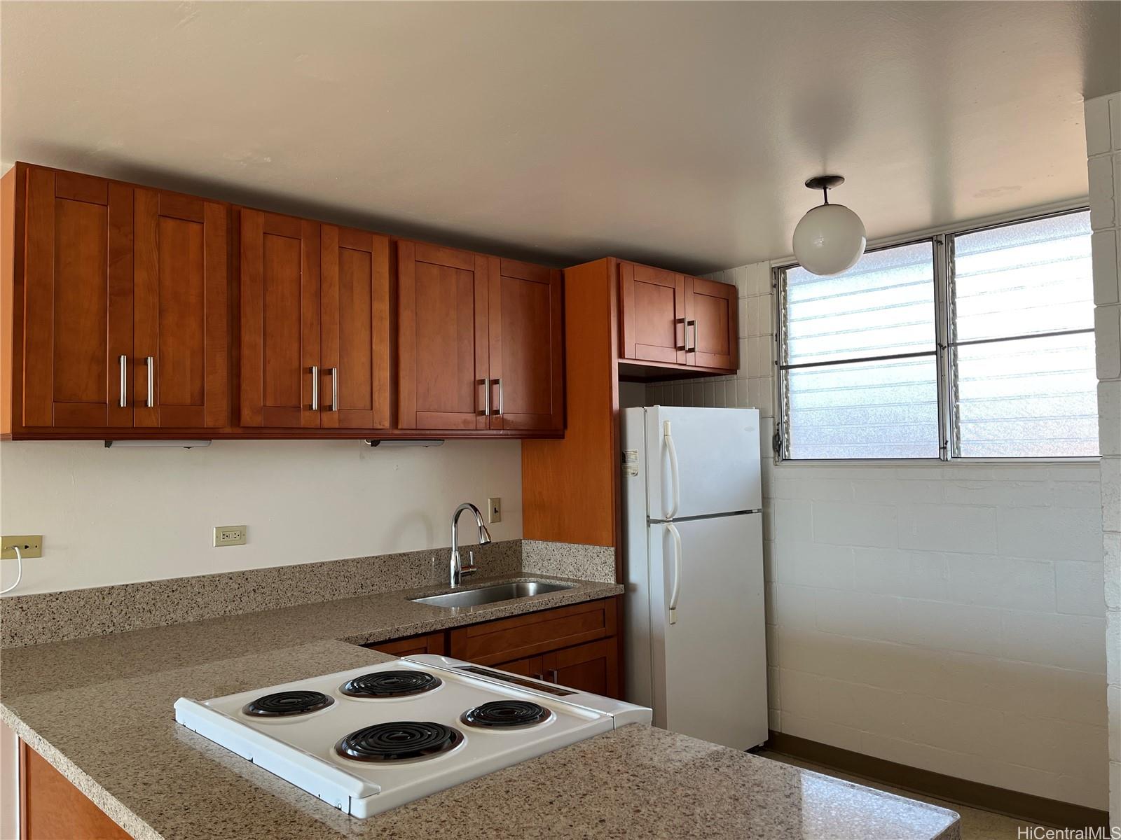 a kitchen with a refrigerator and a sink