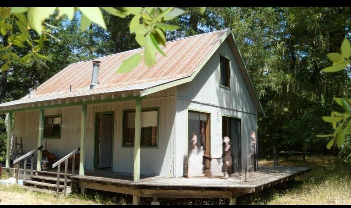 a view of house with backyard water fountain and sitting area