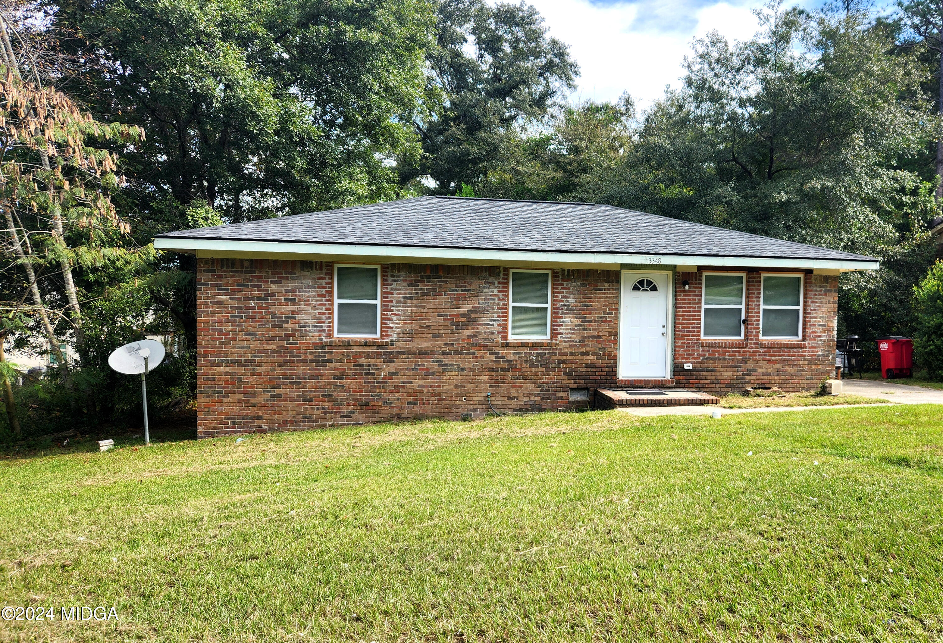 a front view of a house with a garden