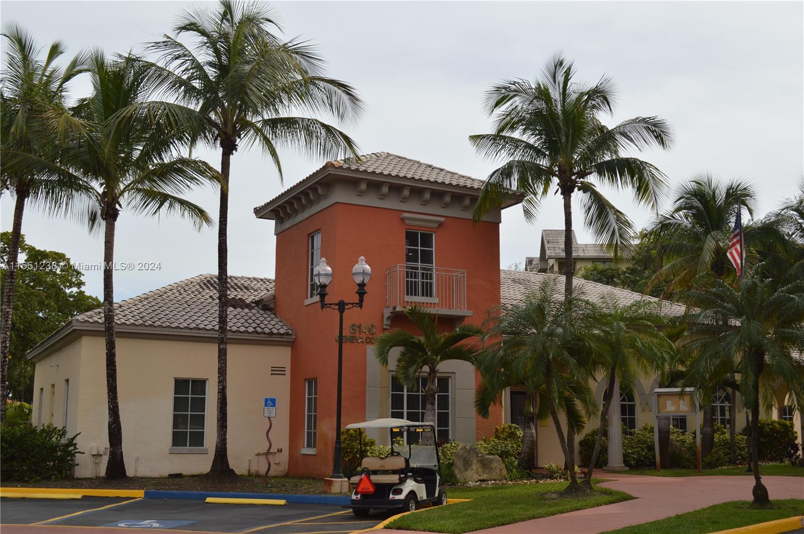 a front view of multiple houses with palm trees