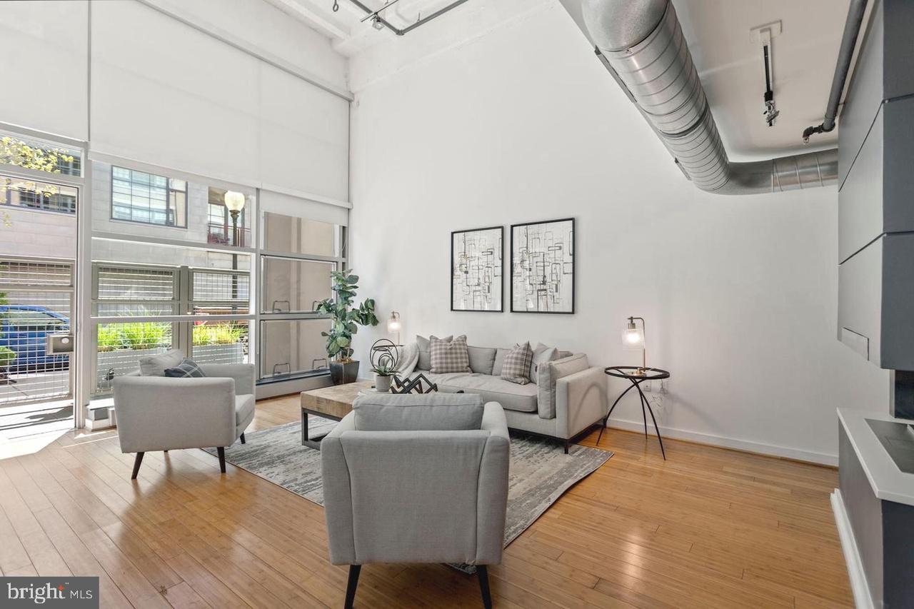 a living room with furniture wooden floor and a table