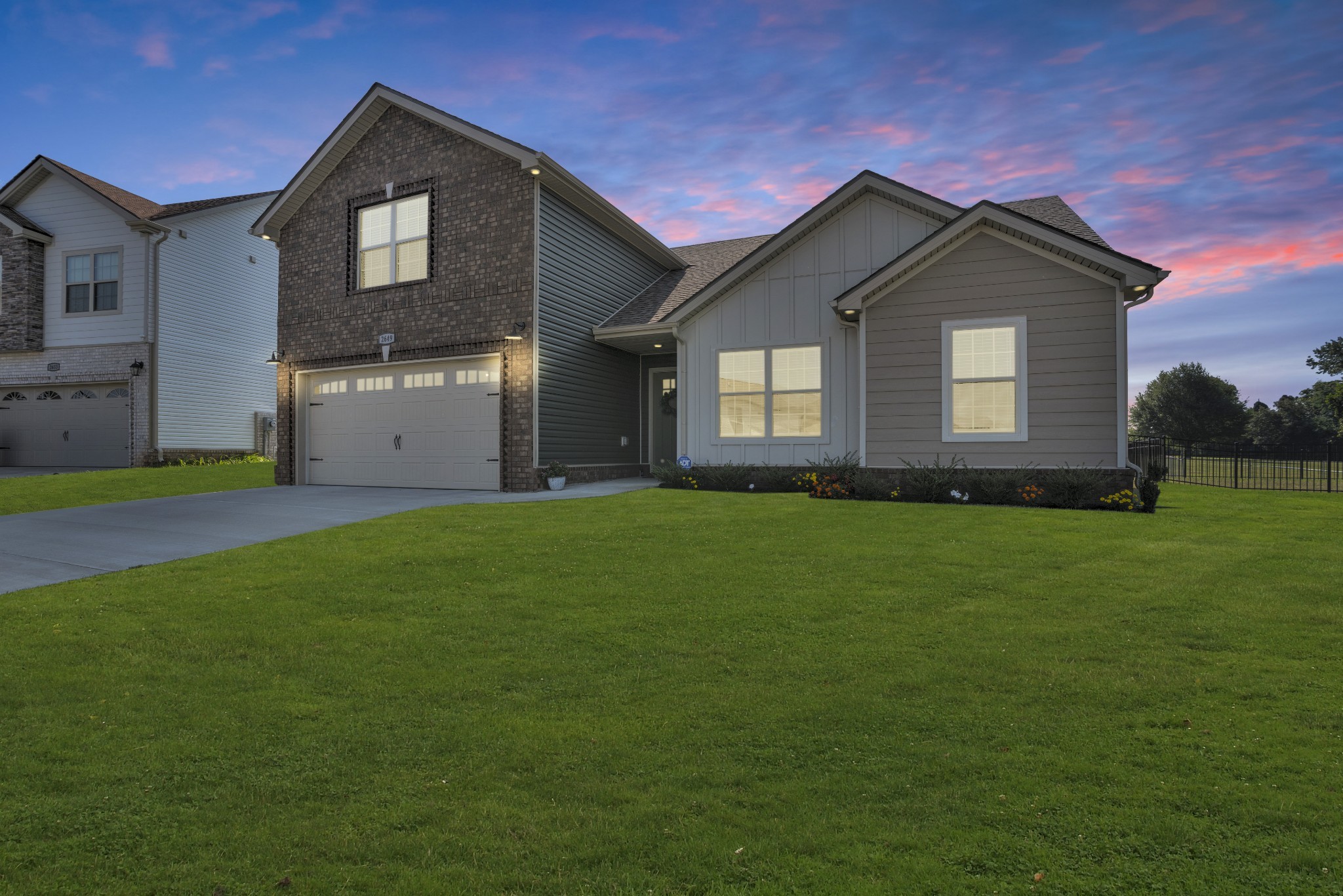 a front view of house with yard and green space