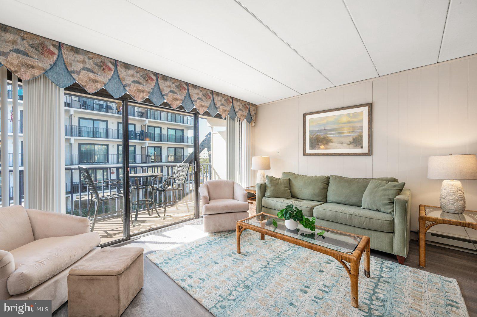 a living room with furniture a rug and a large window