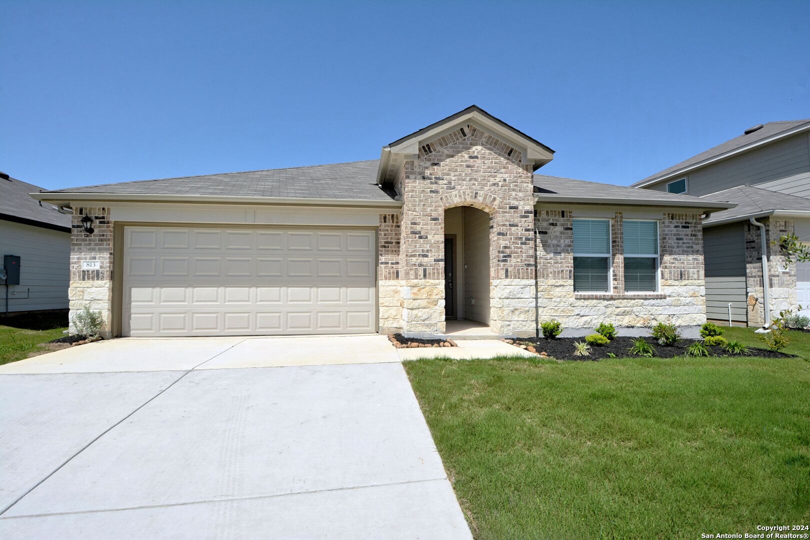 a front view of a house with a yard