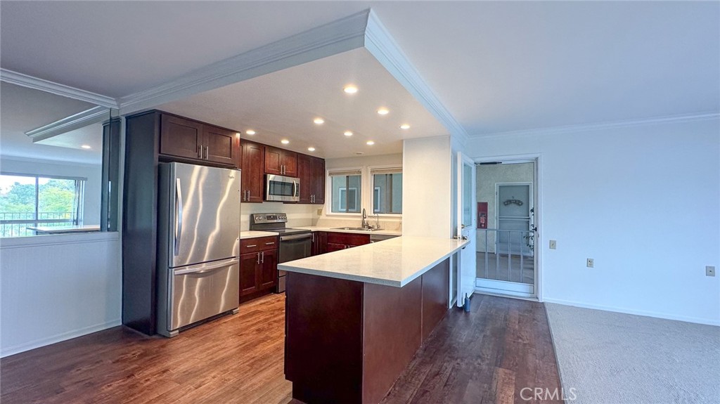 a kitchen with stainless steel appliances granite countertop a refrigerator and a sink