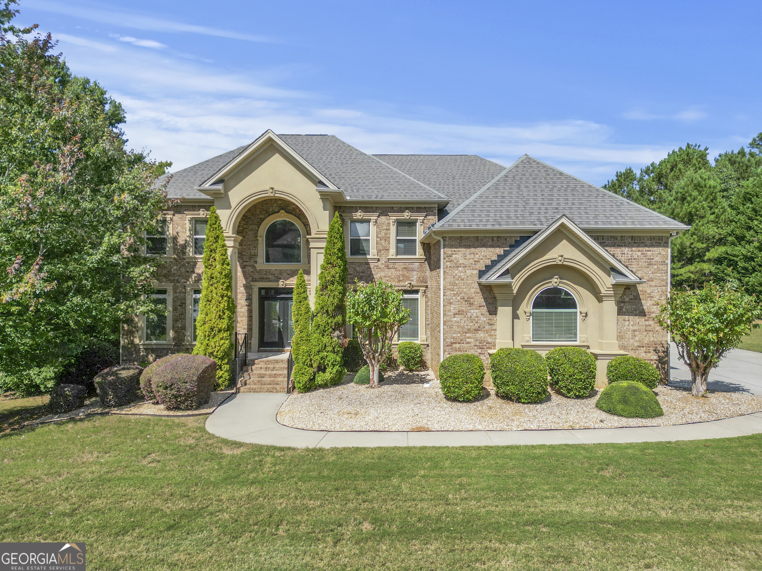 a front view of a house with a yard and garage