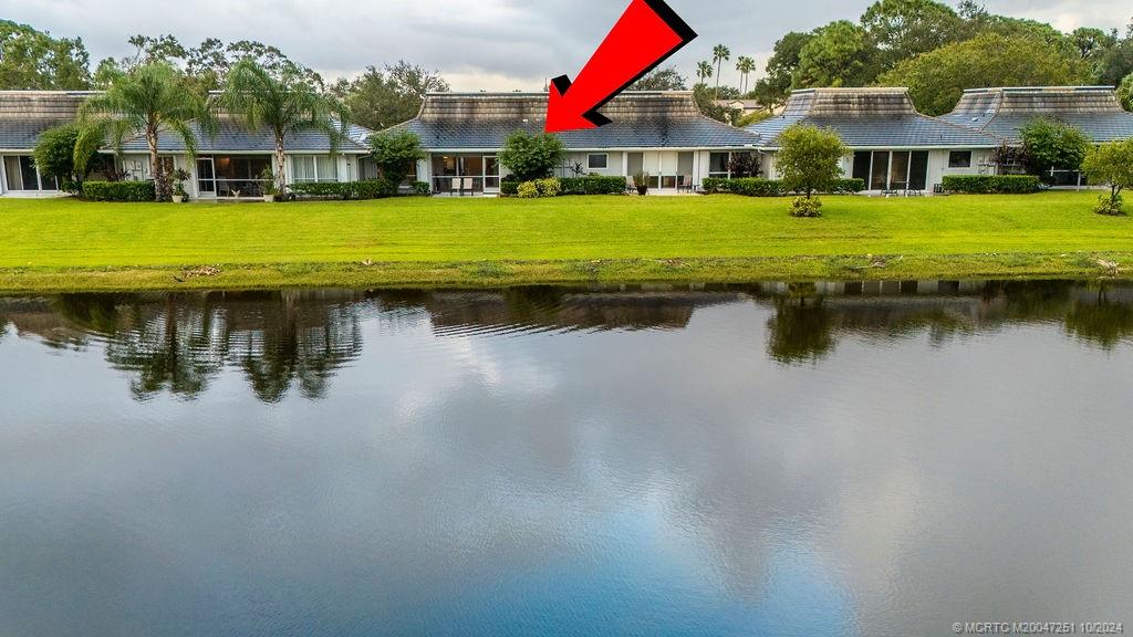 a view of a house with pool and a yard