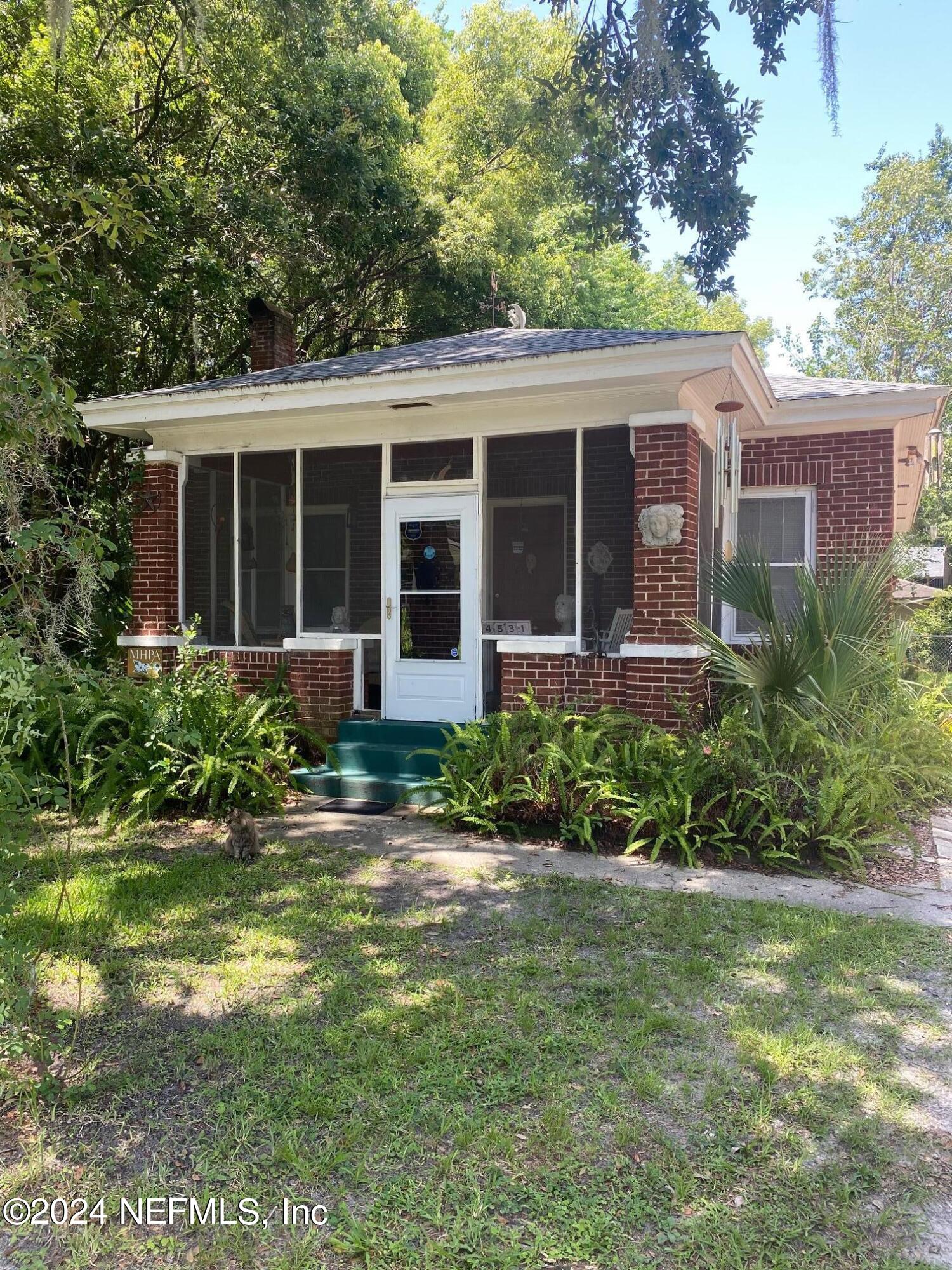 a view of a house with garden and porch