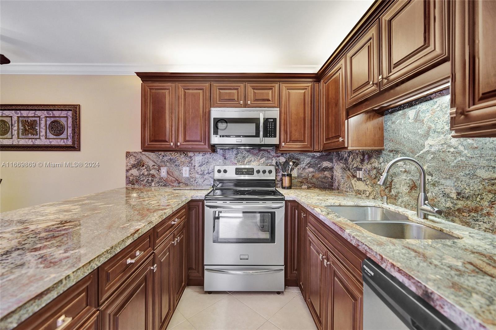 a kitchen with granite countertop a sink stove and cabinets