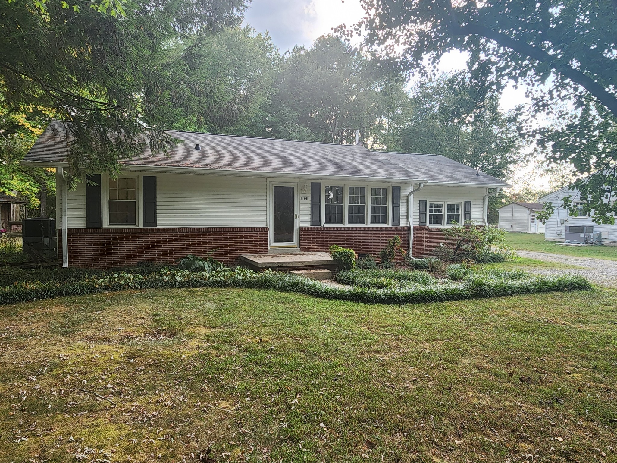 a view of a house with a garden and plants