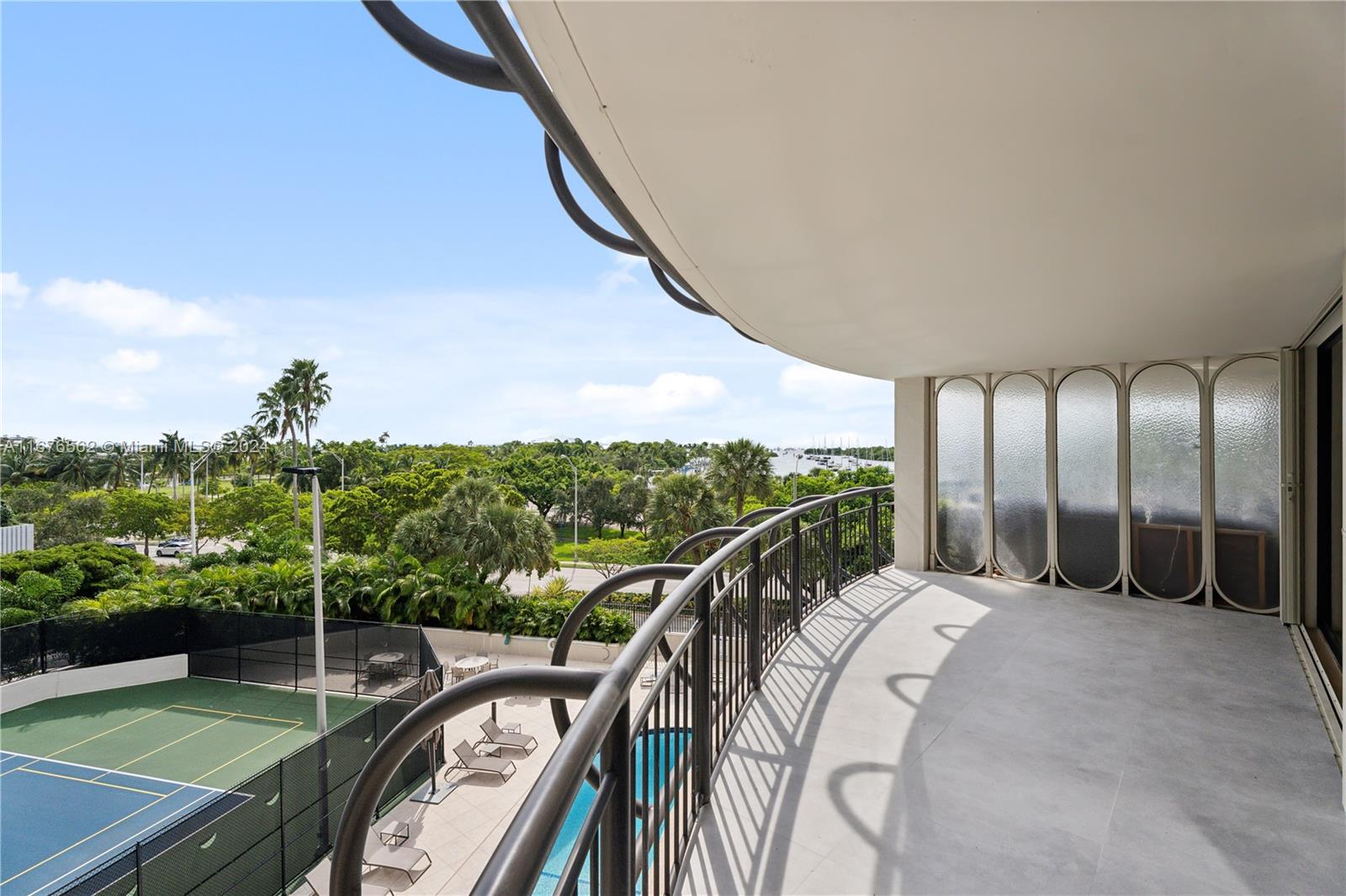 a view of a balcony with yard