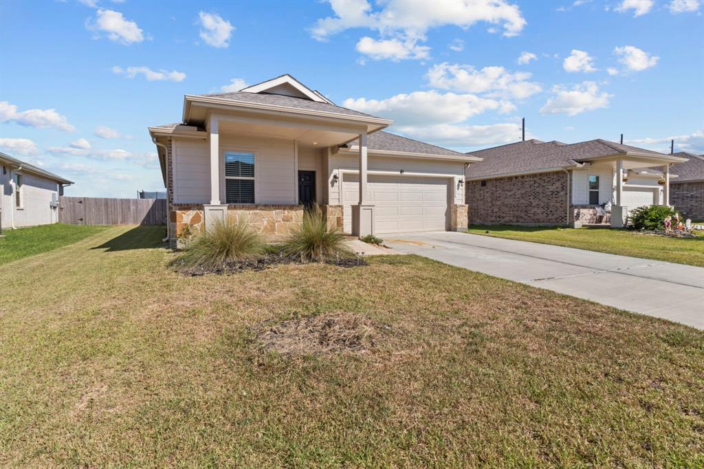 a view of a house with a yard and garage