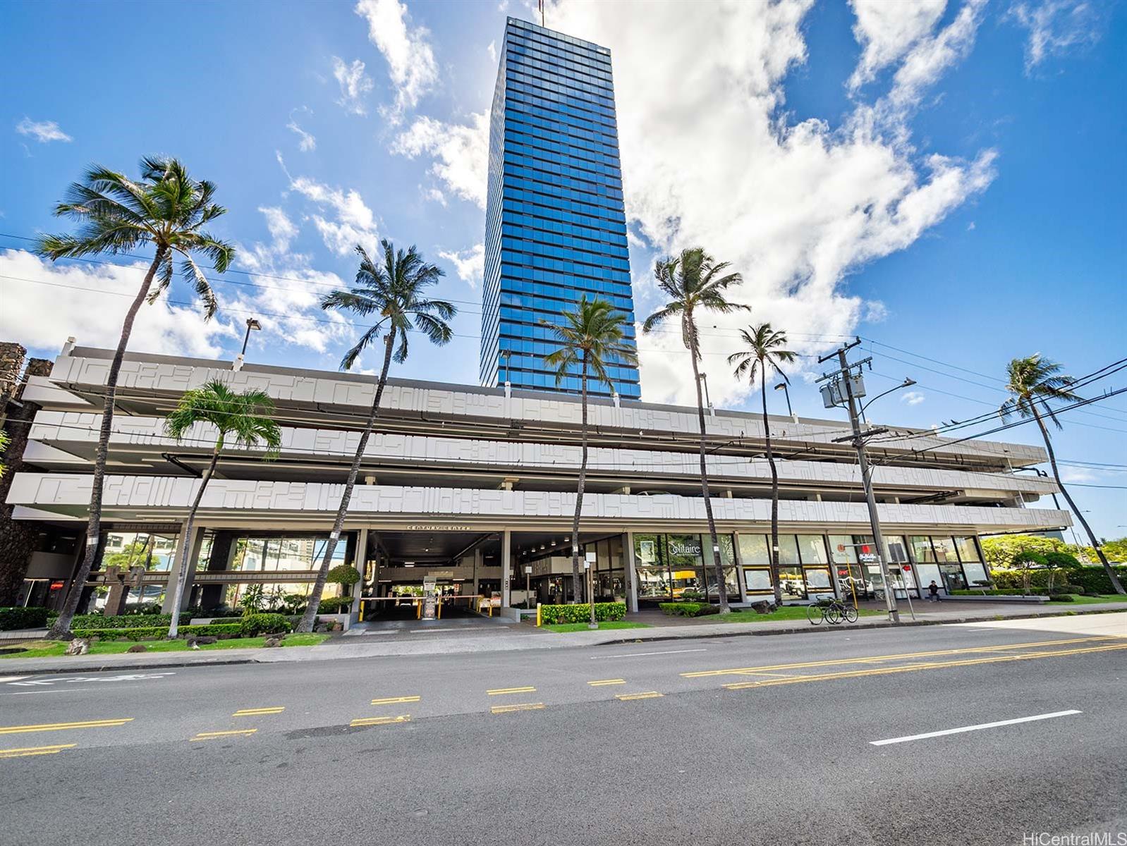 a front view of building with cars parked