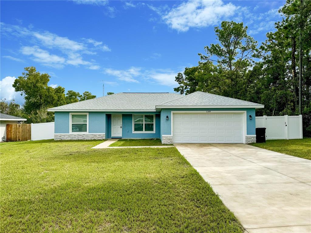 a front view of a house with yard