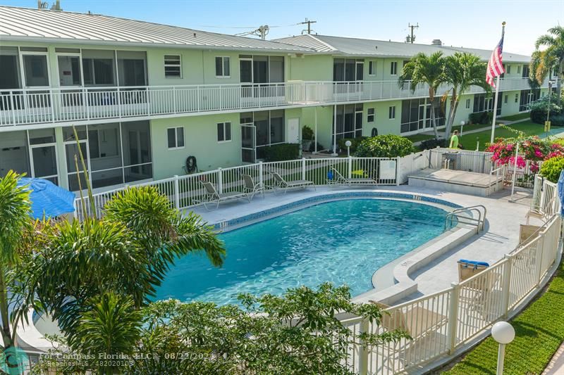 a view of a house with pool and sitting area