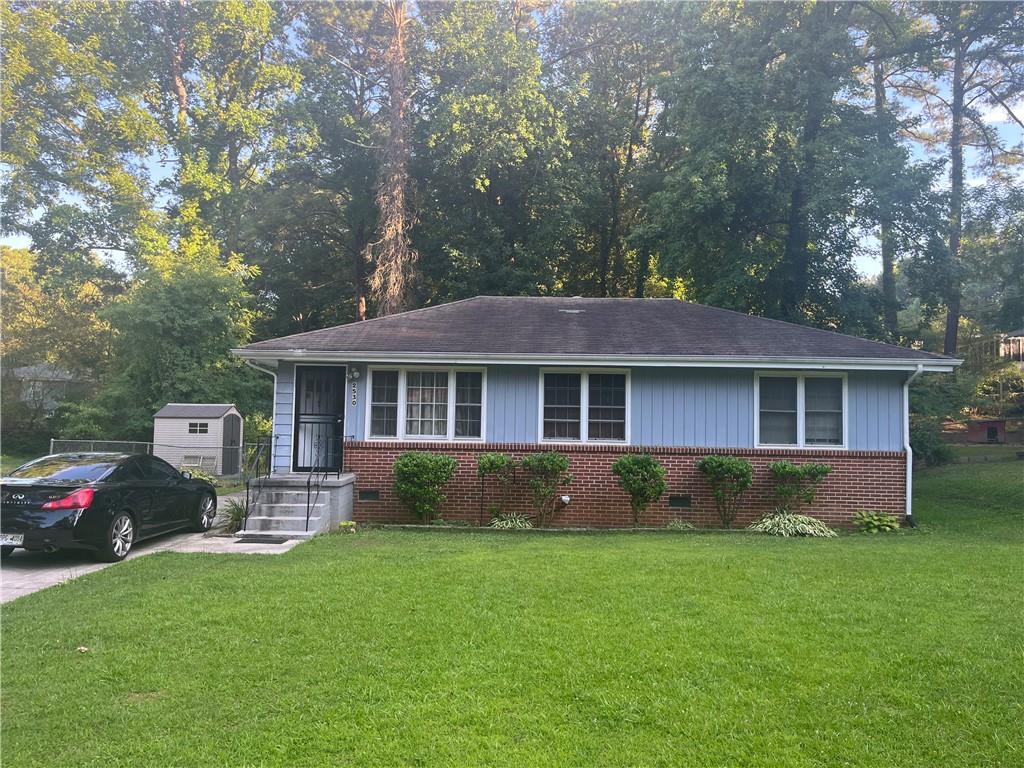 a front view of a house with a garden and plants