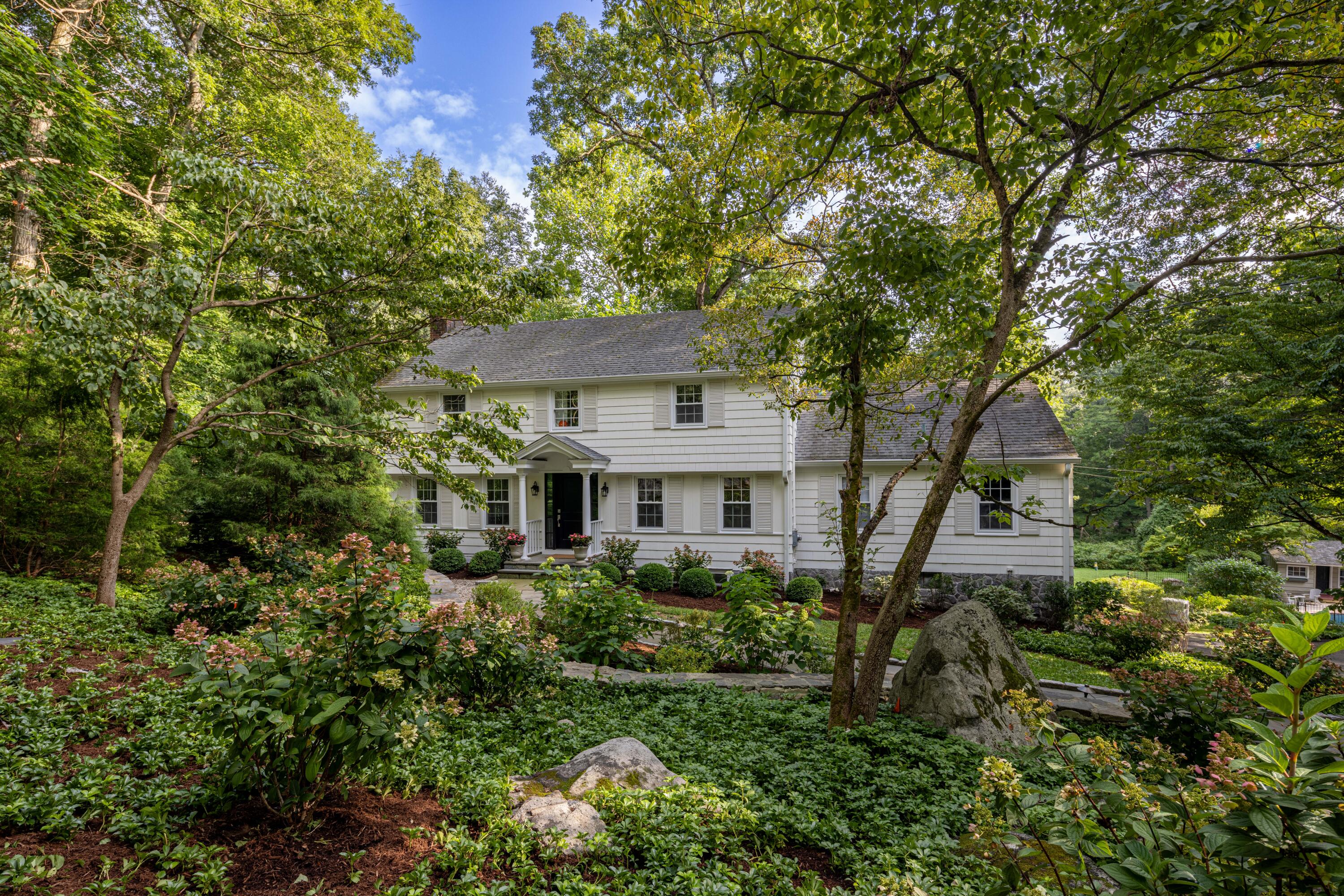 front view of a house with a tree