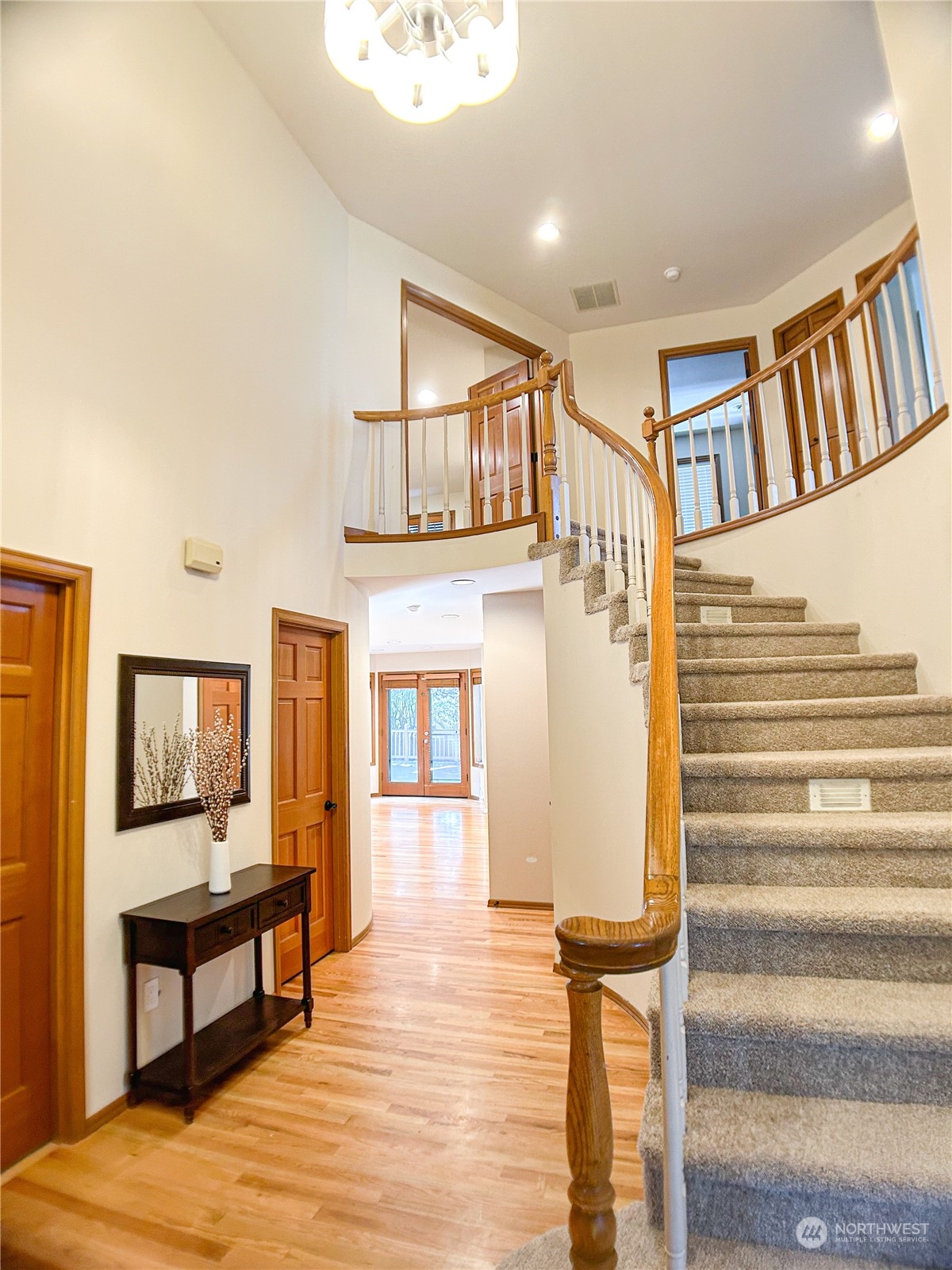 a view of front door with furniture and wooden floor