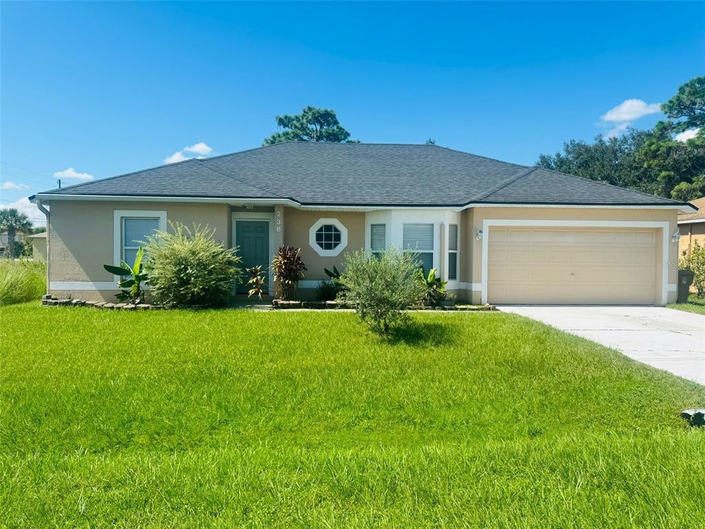 a front view of house with yard and green space