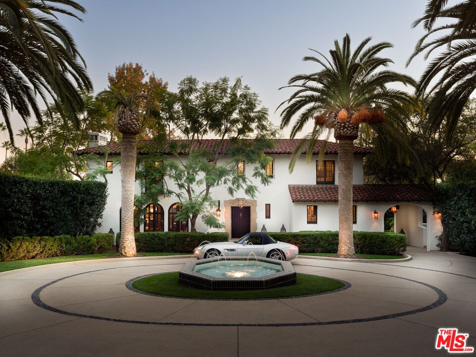 a house with palm tree in front of it