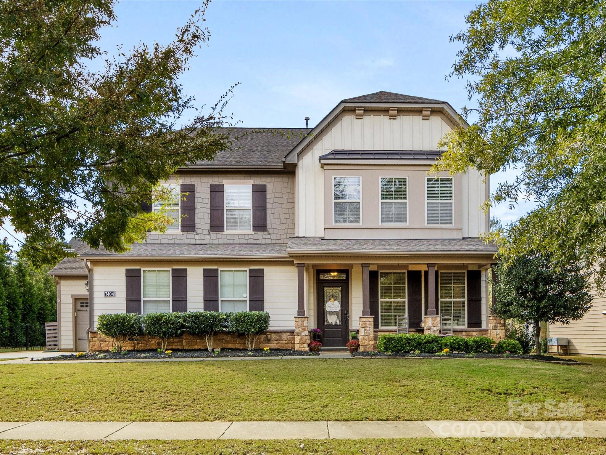 front view of a brick house with a yard