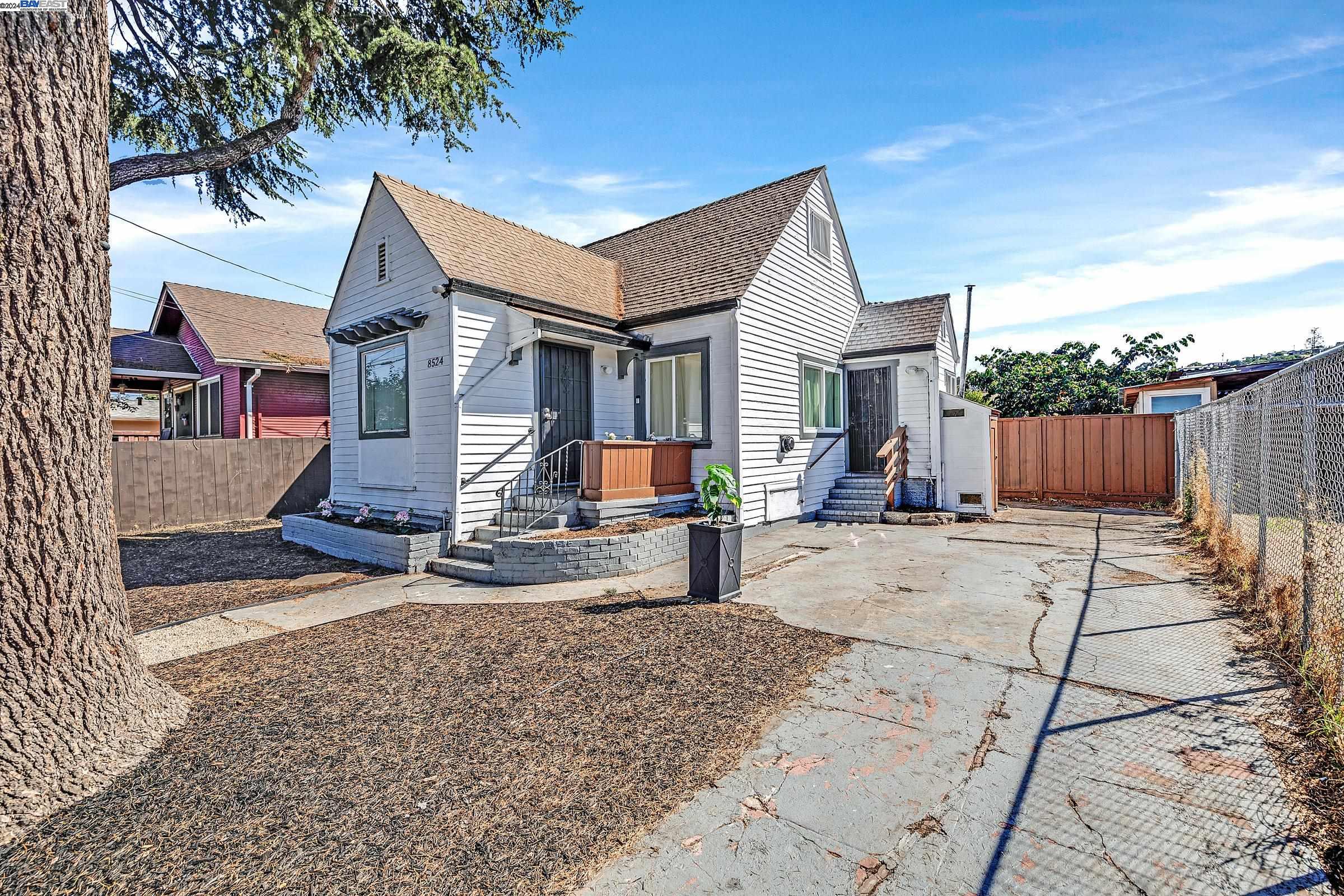 a view of a house with wooden fence