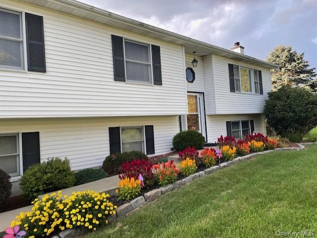 Split foyer home with a front yard