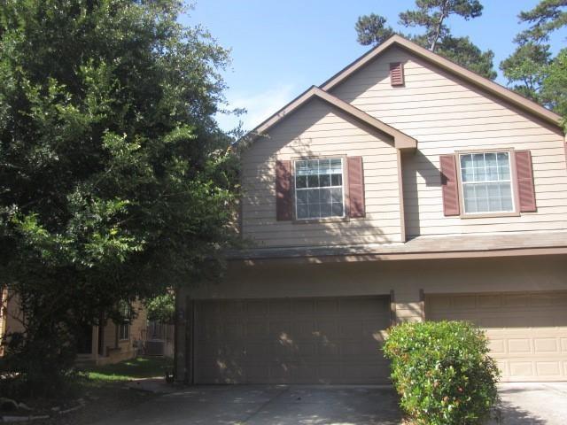 a view of house with a tree