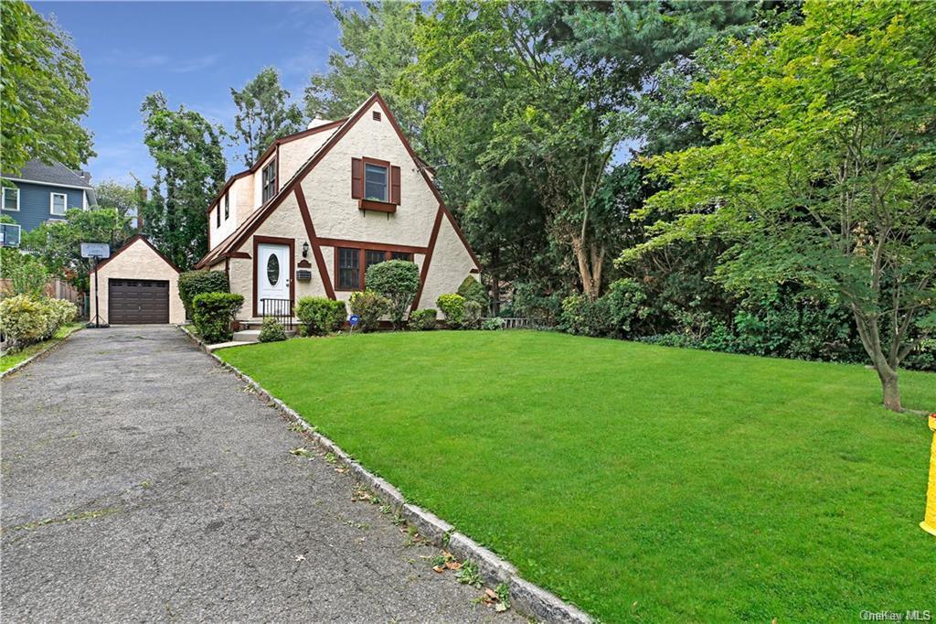 a front view of house with yard and green space