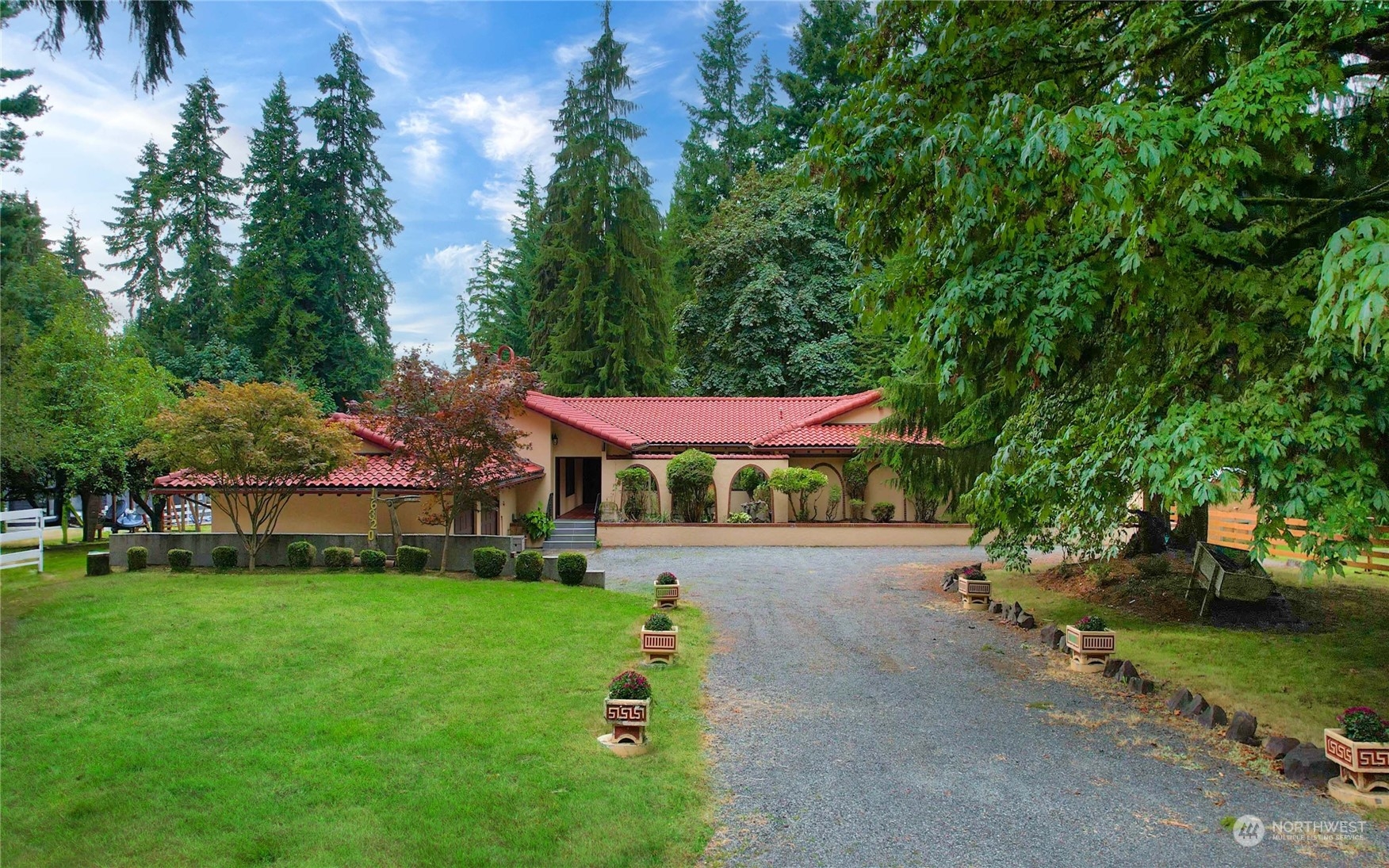 a front view of house with yard and trees