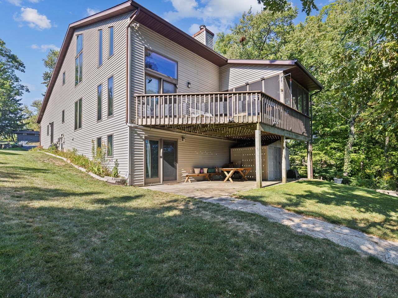 a view of a house with a yard and sitting area