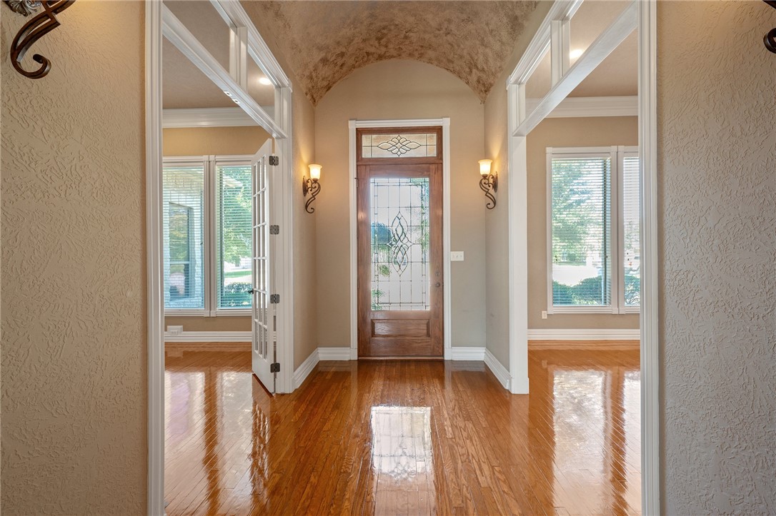 Doorway featuring crown molding and light wood-typ