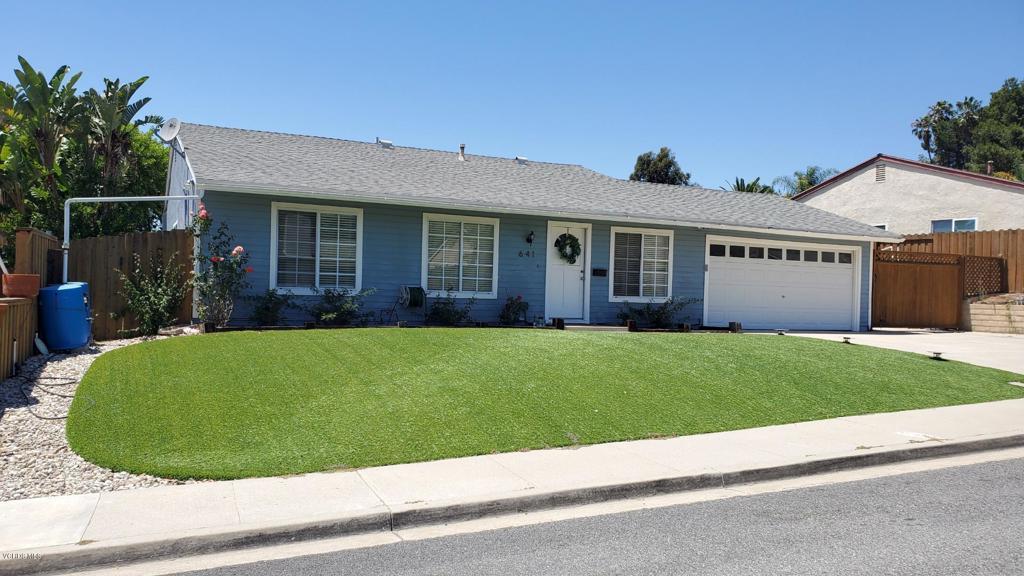 a view of a house with a garden and plants