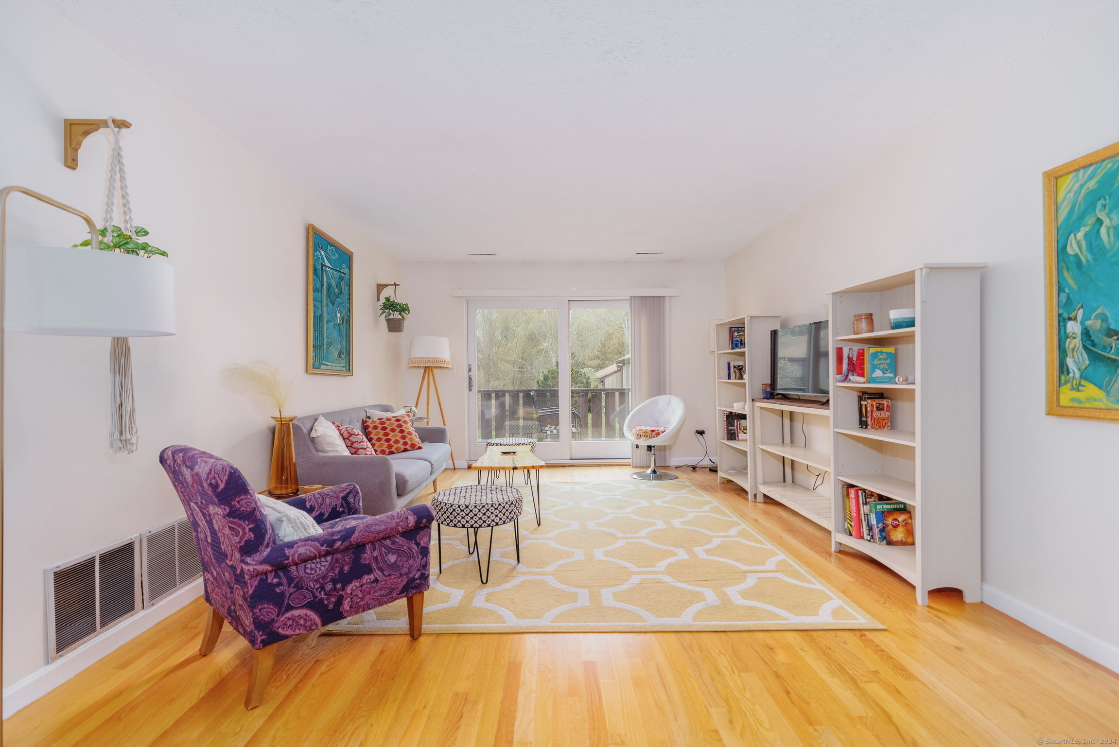 a living room with furniture and a book shelf