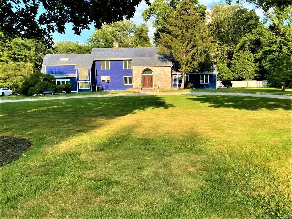 a front view of house with yard and green space