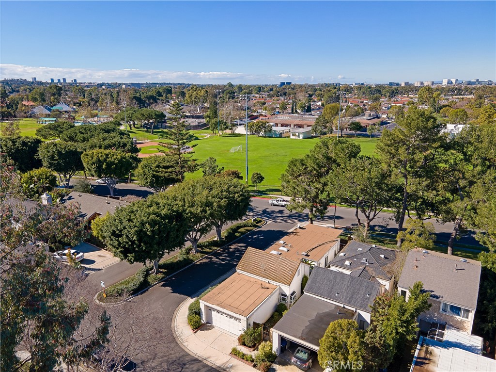 an aerial view of residential houses with outdoor space