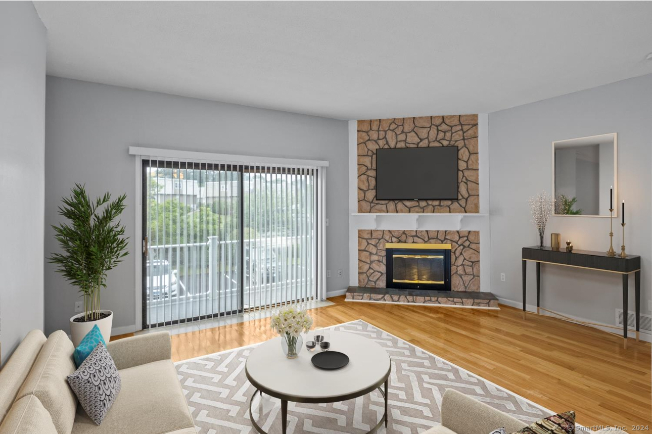 a living room with furniture a fireplace and a table