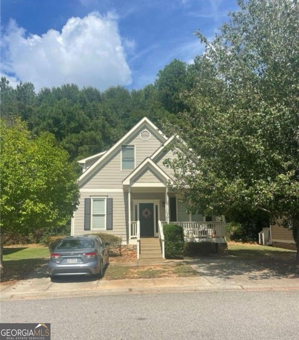 a front view of a house with a garden