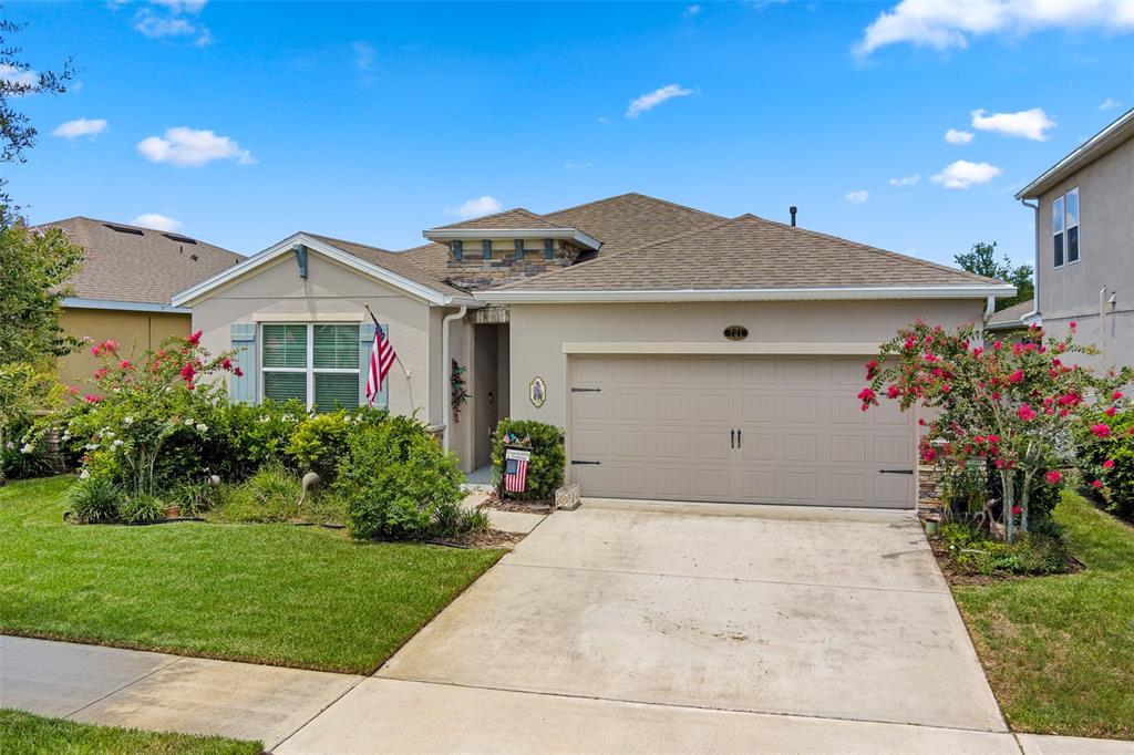 a front view of a house with a yard and garage