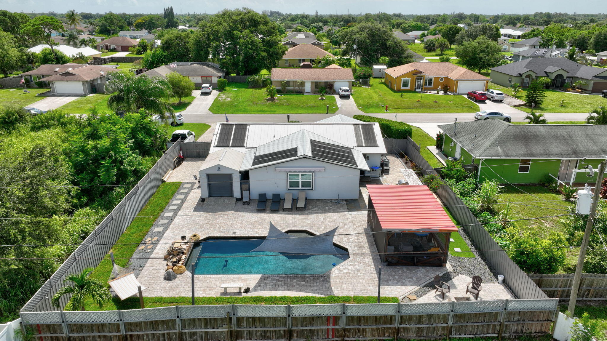 an aerial view of house with yard swimming pool and outdoor seating