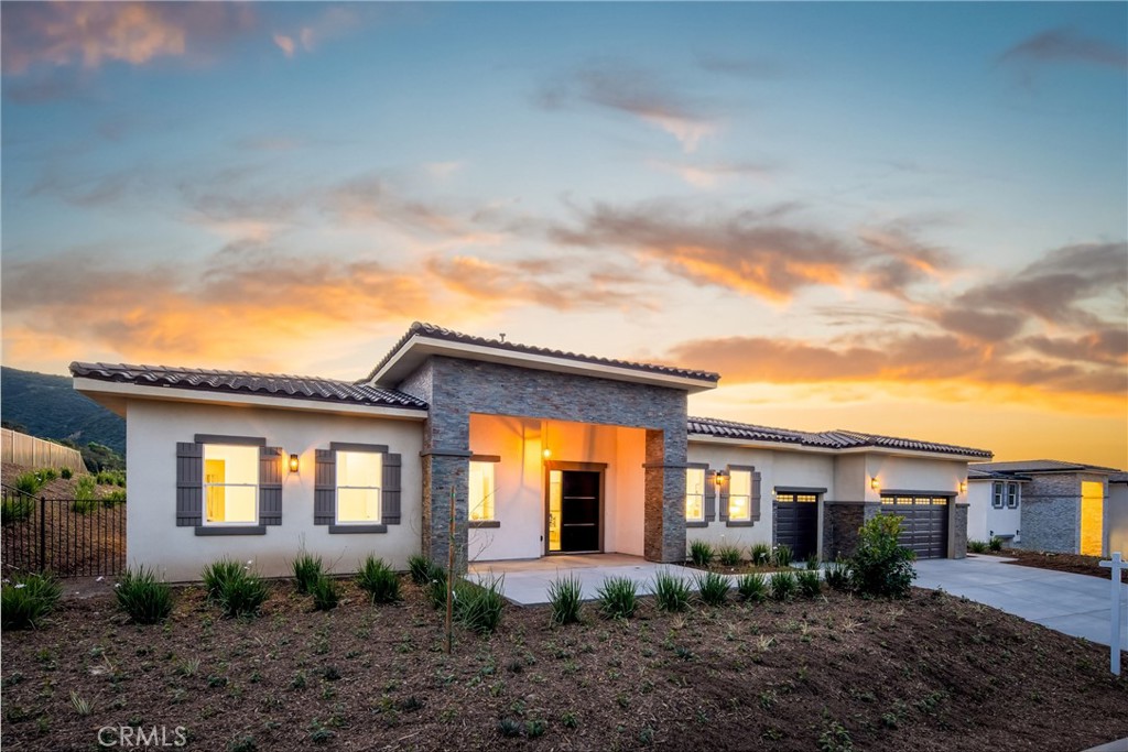 a view of a brick house next to a yard