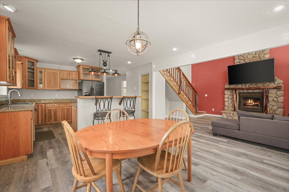 a dining room with furniture and wooden floor